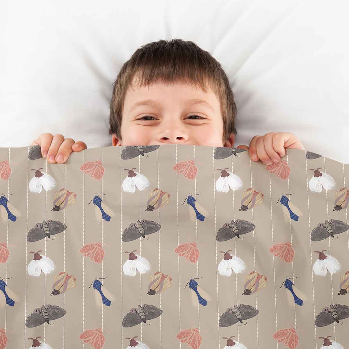 Housse à motifs pour couverture lestée enfant, imprimé Papillons de nuit, tenue par un enfant