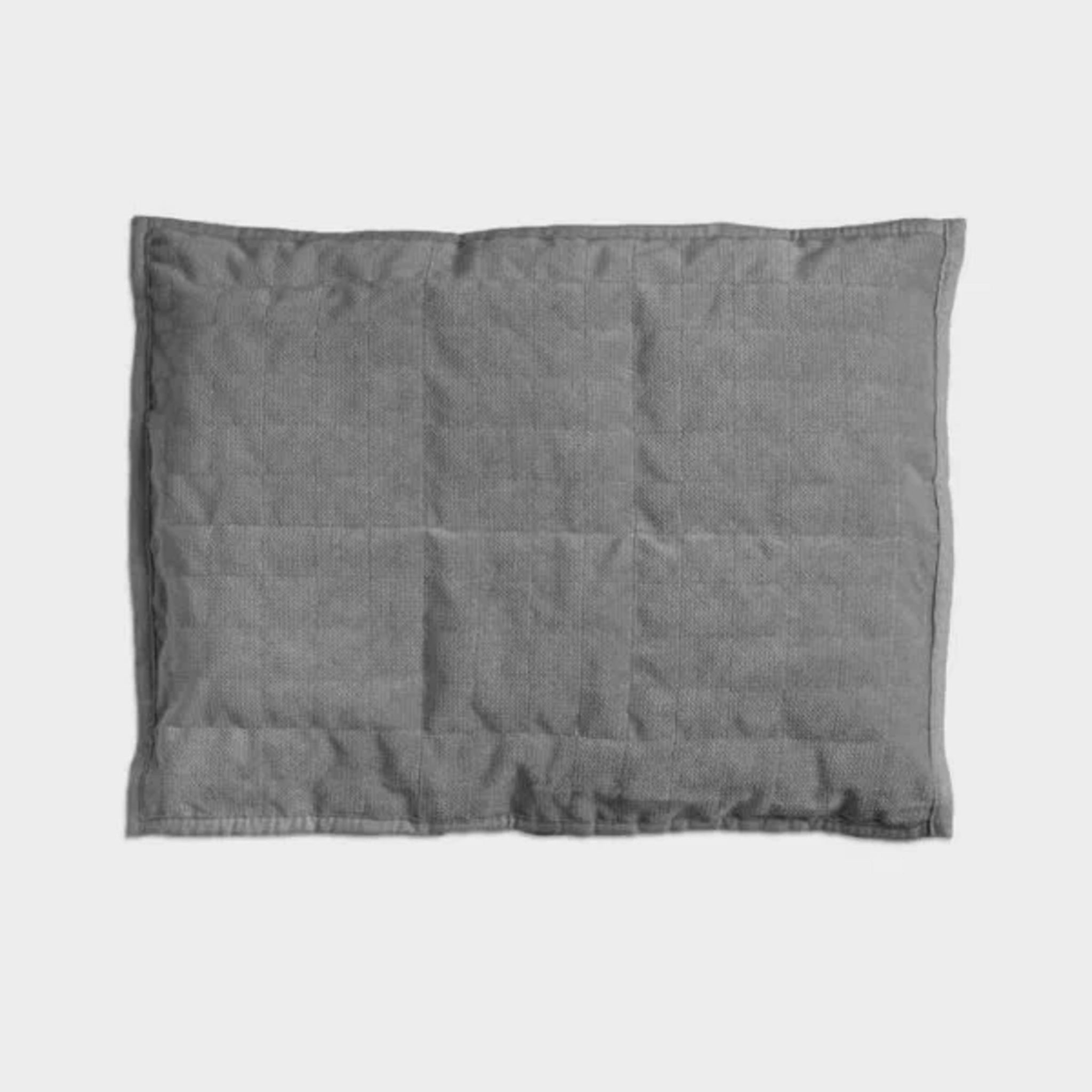 Coussin lesté pour les genoux, posé sur les jambes