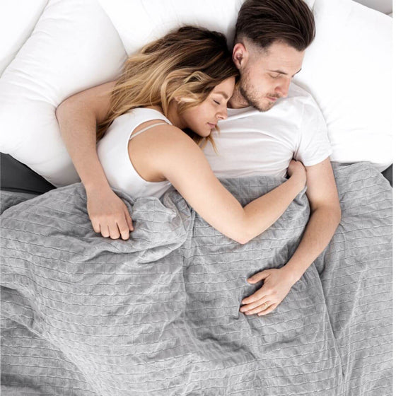 Couple enlacé sous la couverture lestée DUO